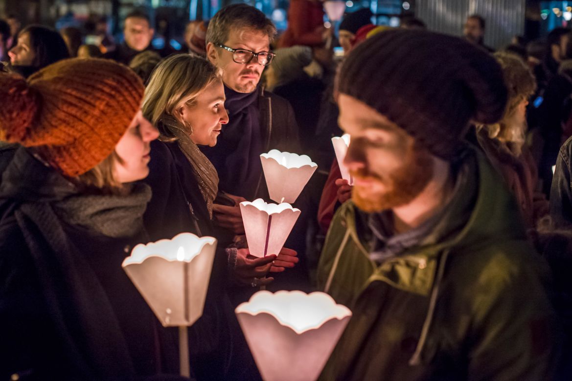 People in Brussels, Belgium, hold candles during a vigil on January 7.