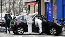 French police officers and forensic experts examine the car used by armed gunmen who stormed the Paris offices of satirical newspaper Charlie Hebdo, killing 12 people, on January 7, 2015 in Paris.