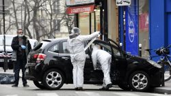 French police officers and forensic experts examine the car used by armed gunmen who stormed the Paris offices of satirical newspaper Charlie Hebdo, killing 12 people, on January 7, 2015 in Paris. 