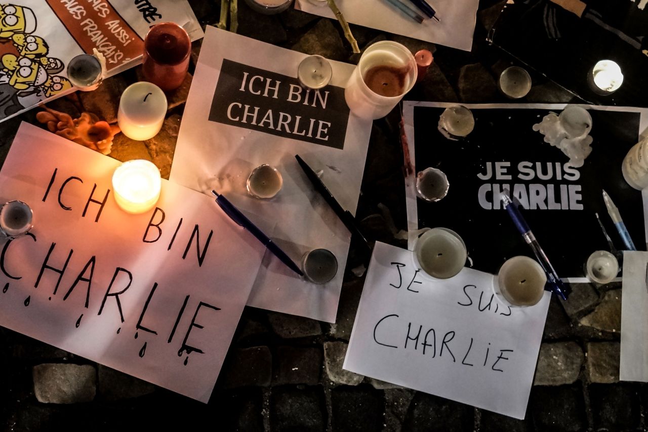 Papers with "I am Charlie" written in various languages are left near candles at a vigil in front of the French Embassy in Berlin.