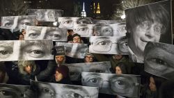 Mourners hold signs depicting victim's eyes during a rally in support of Charlie Hebdo, a French satirical weekly newspaper that fell victim to an terrorist attack, Wednesday, Jan. 7, 2015, at Union Square in New York. French officials say 12 people were killed when masked gunmen stormed the Paris offices of the periodical that had caricatured the Prophet Muhammad. (AP Photo/John Minchillo)