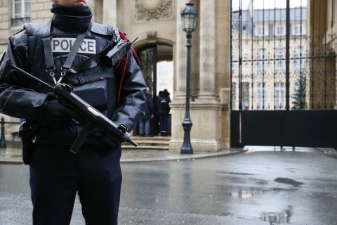 A police officer stands guard in front of Paris' Elysee Palace on January 8.
