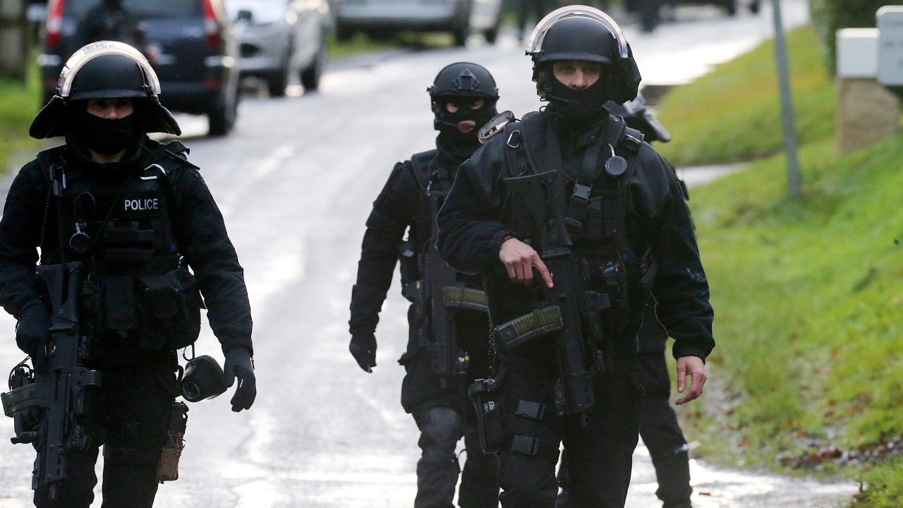 French police special forces patrol a street in Corcy, France, on January 8.