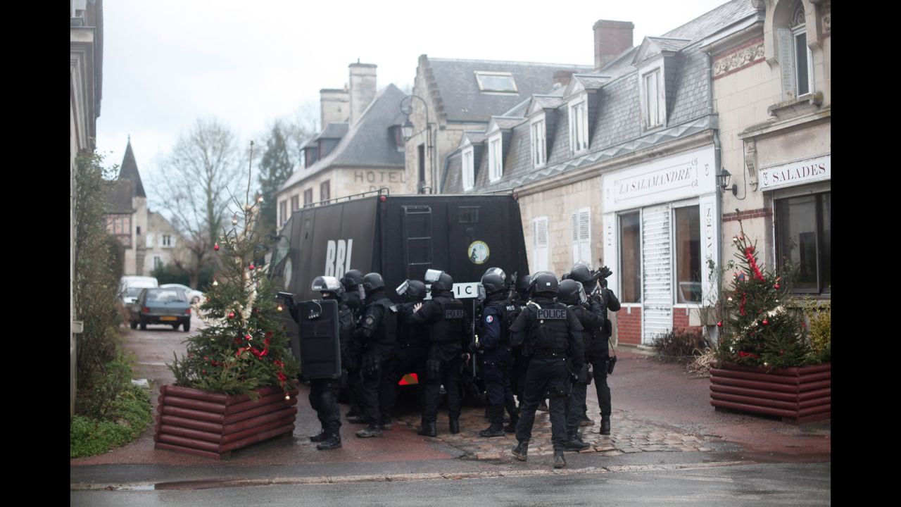 French police officers gather January 8 in Longpont, France, about 10 kilometers (6.2 miles) from where the suspects were reportedly spotted.