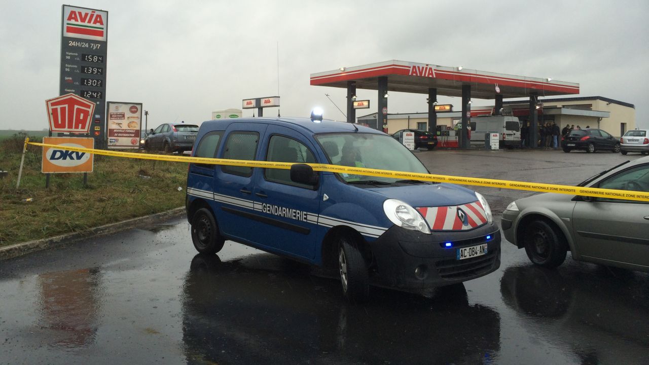 On January 8, police tape and vehicles block off the entrance to a gas station north of Paris where the two suspects were reportedly seen the night before.
