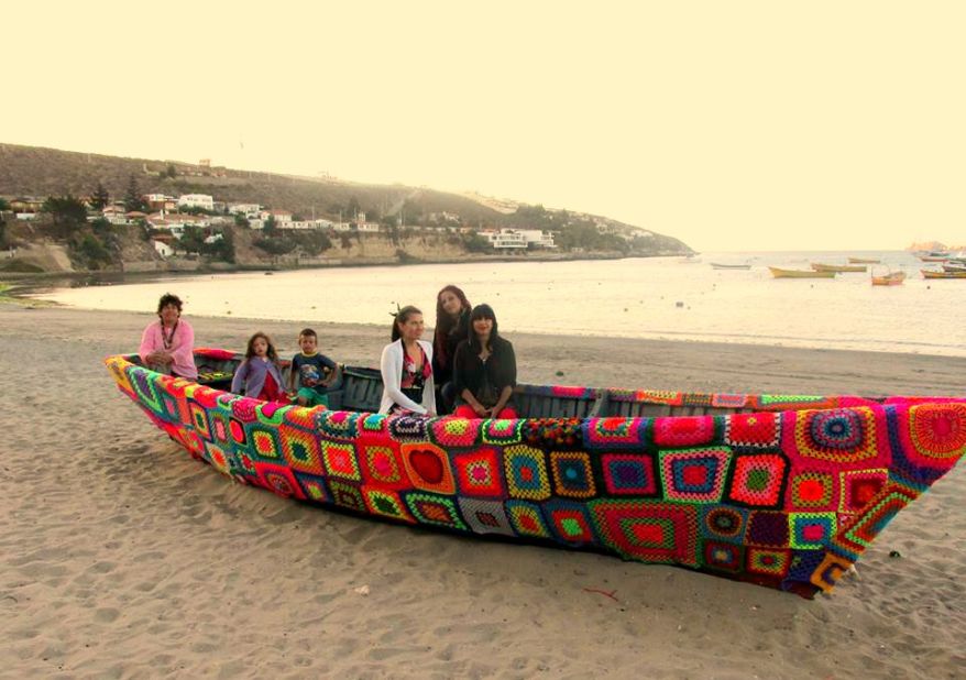 Members of Lanapuerto take a rest from their work after covering a fishing boat in colorful wool. 
