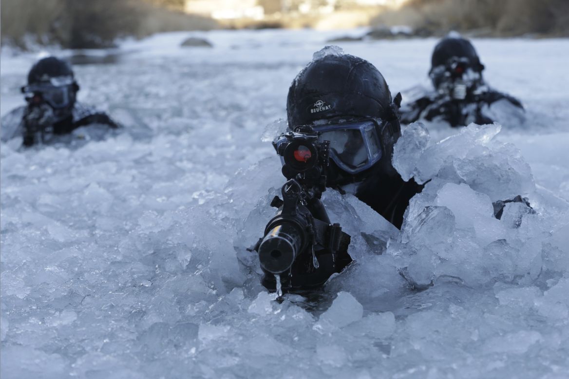 JANUARY 8 - PYEONGCHANG, SOUTH KOREA: South Korea's Army Special Warfare Command (SWC) soldiers aim their machine guns in a frozen river during a winter exercise. About 200 SWC soldiers participated in this routine drill that lasts for two weeks. 