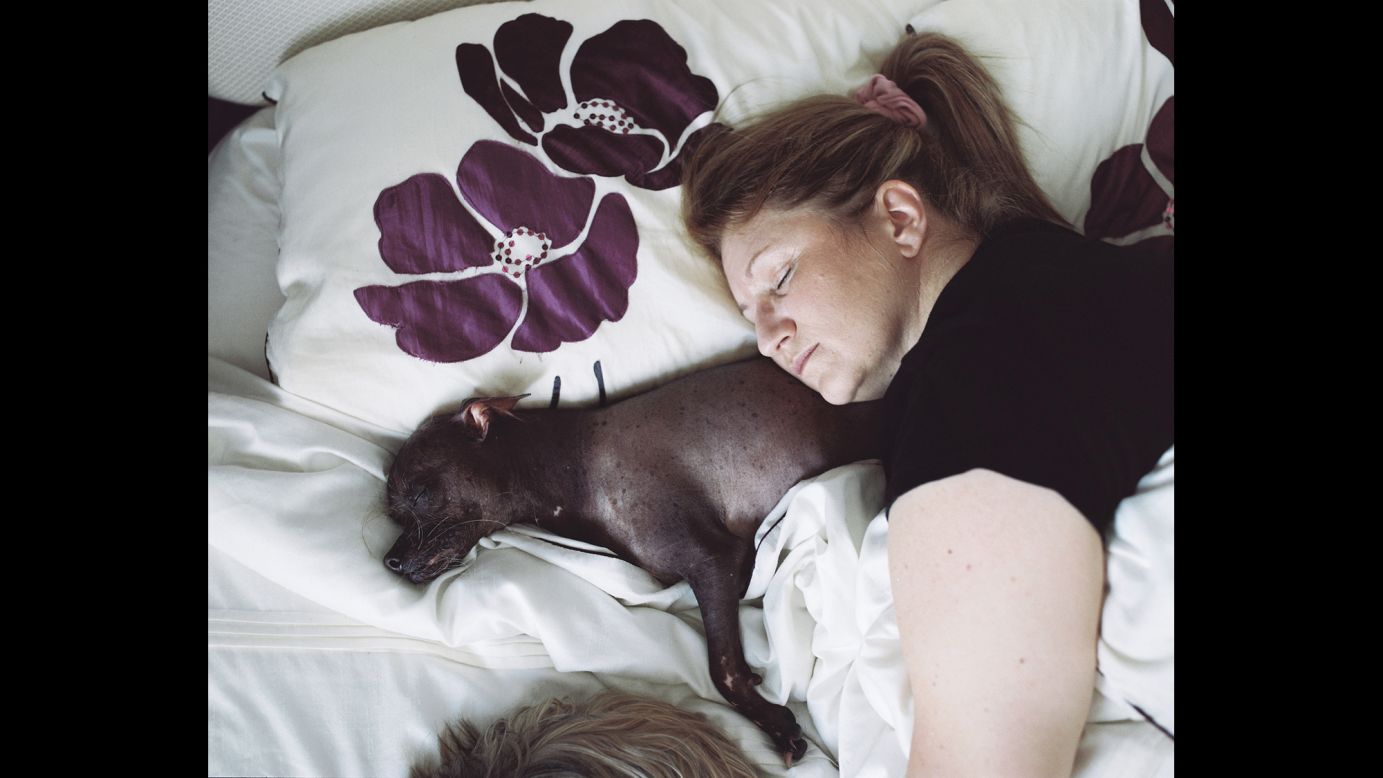 Every night, Mugly sleeps with his owner, Bev Nicholson.