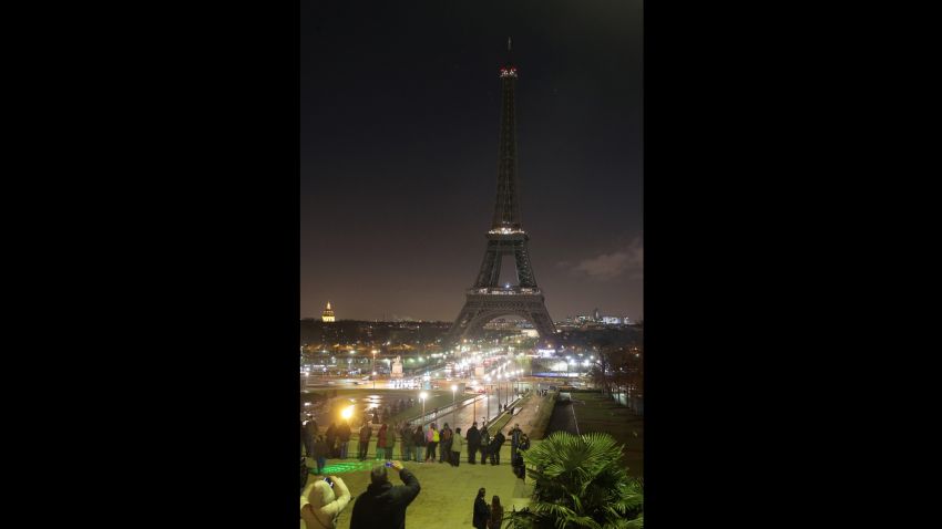 The Eiffel tower's lights are switched off in Paris on January 8, 2015, in tribute to the twelve people killed the day before in an attack by two armed gunmen on the offices of French satirical newspaper Charlie Hebdo in Paris. A huge manhunt for two brothers suspected of massacring 12 people in an Islamist attack at a satirical French weekly zeroed in on a northern town after the discovery of one of the getaway cars. As thousands of police tightened their net, the country marked a rare national day of mourning for Wednesday's bloodbath at Charlie Hebdo magazine in Paris, the worst terrorist attack in France for half a century. AFP PHOTO / JACQUES DEMARTHON (Photo credit should read JACQUES DEMARTHON/AFP/Getty Images)