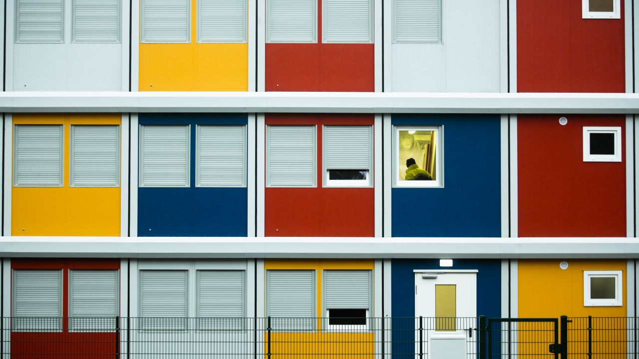 A construction worker in Berlin walks up the staircase of a so-called container village for refugees on Monday, January 5. The containers were built as temporary living quarters for the rising number of refugees applying for asylum in the German capital.