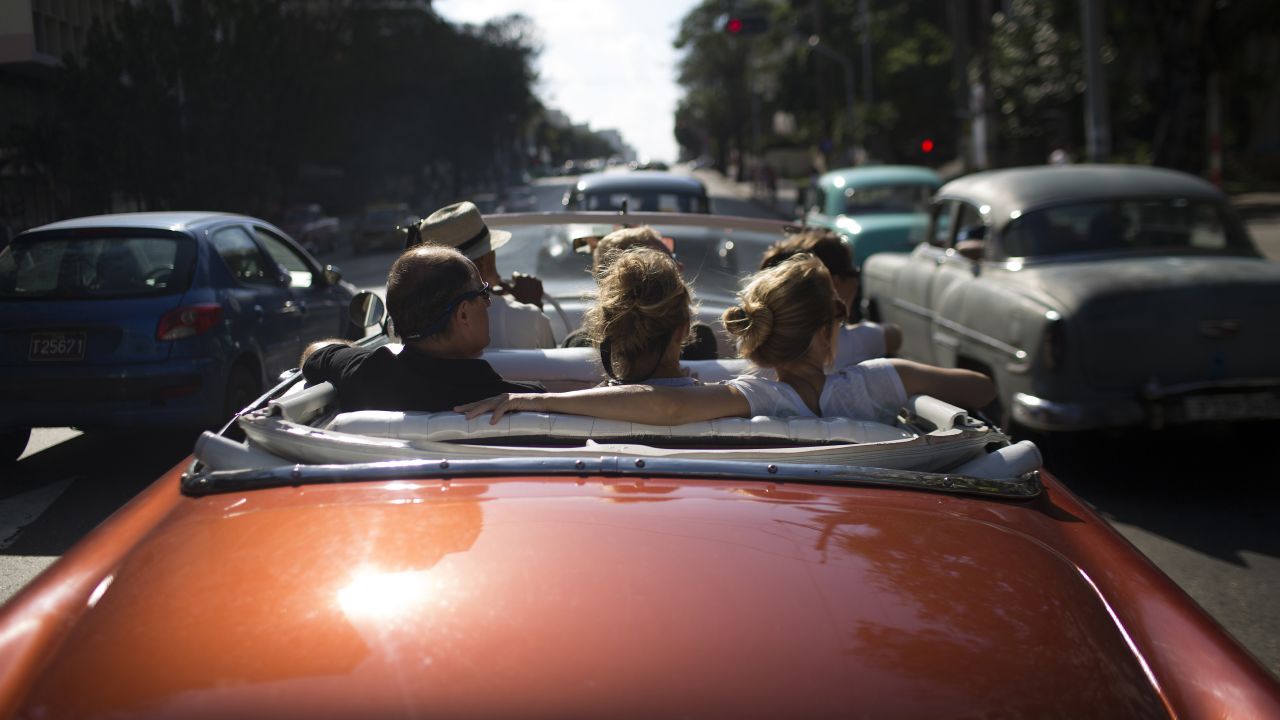 Tourists ride in a convertible in Havana, Cuba, on Tuesday, January 6.