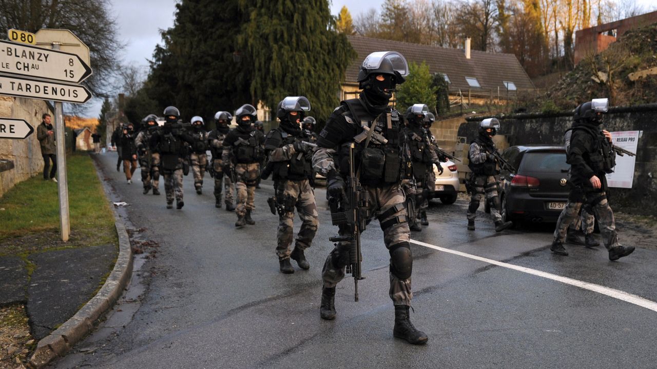 Police walk down a street in Corcy, France, on Thursday, January 8, as <a href="http://www.cnn.com/2015/01/08/world/gallery/manhunt-for-terror-suspects-in-france/index.html" target="_blank">the manhunt continues</a> for two suspects in the Charlie Hebdo shootings.