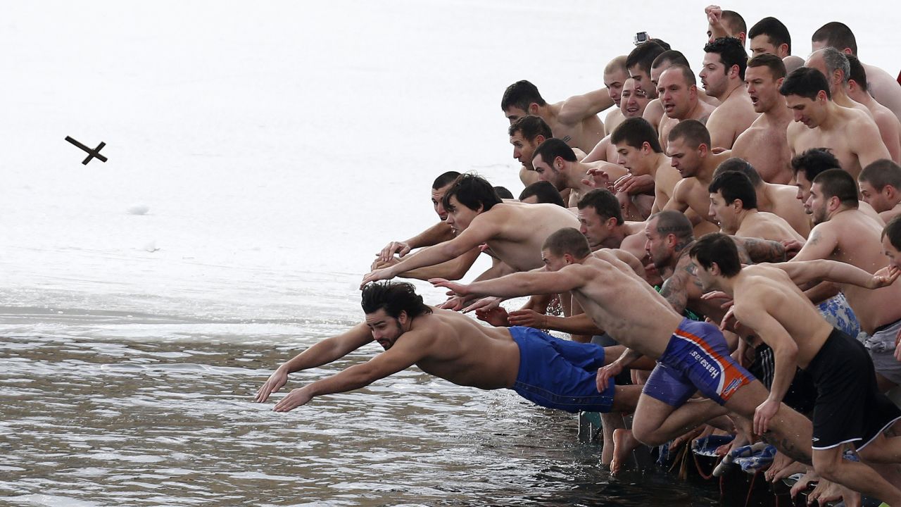 Men in Sofia, Bulgaria, jump into a lake as they try to grab a wooden cross on Epiphany Day, Tuesday, January 6. Orthodox priests throughout the country bless waters by throwing in a cross. It is strongly believed that catching the cross brings health and prosperity to the person who captures it.