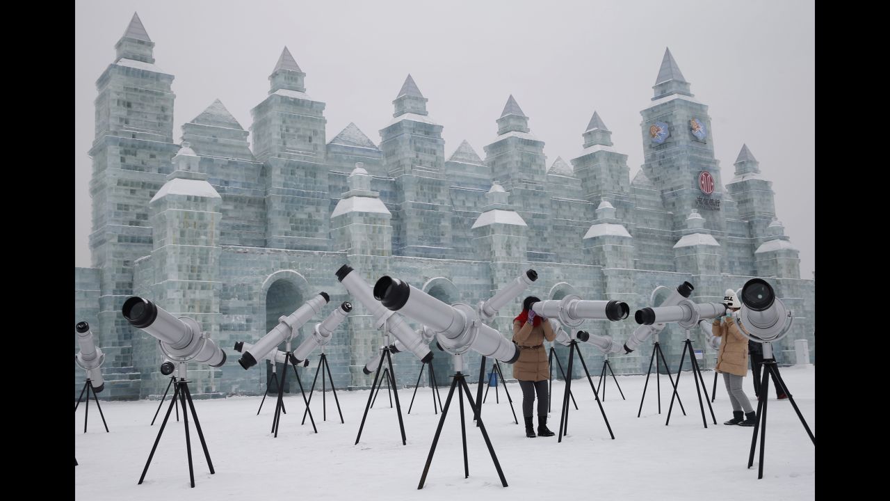 Visitors use kaleidoscopes that are displayed with ice sculptures Sunday, January 4, ahead of the <a href="http://www.cnn.com/2014/01/03/travel/harbin-ice-festival-2014/index.html" target="_blank">Harbin Ice and Snow Festival</a> in Harbin, China.