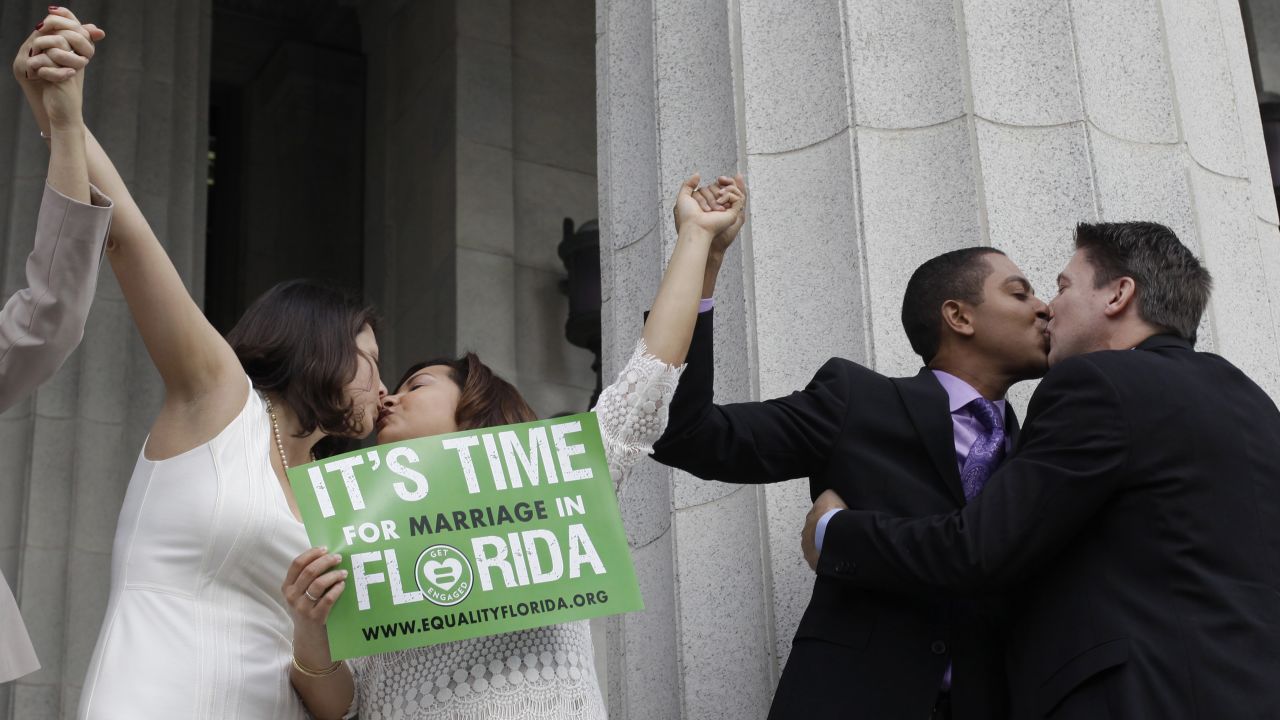 From left, Catherina Pareto, Karla Arguello, Todd Delmay and Jeff Delmay kiss in Miami after getting married Monday, January 5. Florida had just become the 36th state to allow same-sex marriage.
