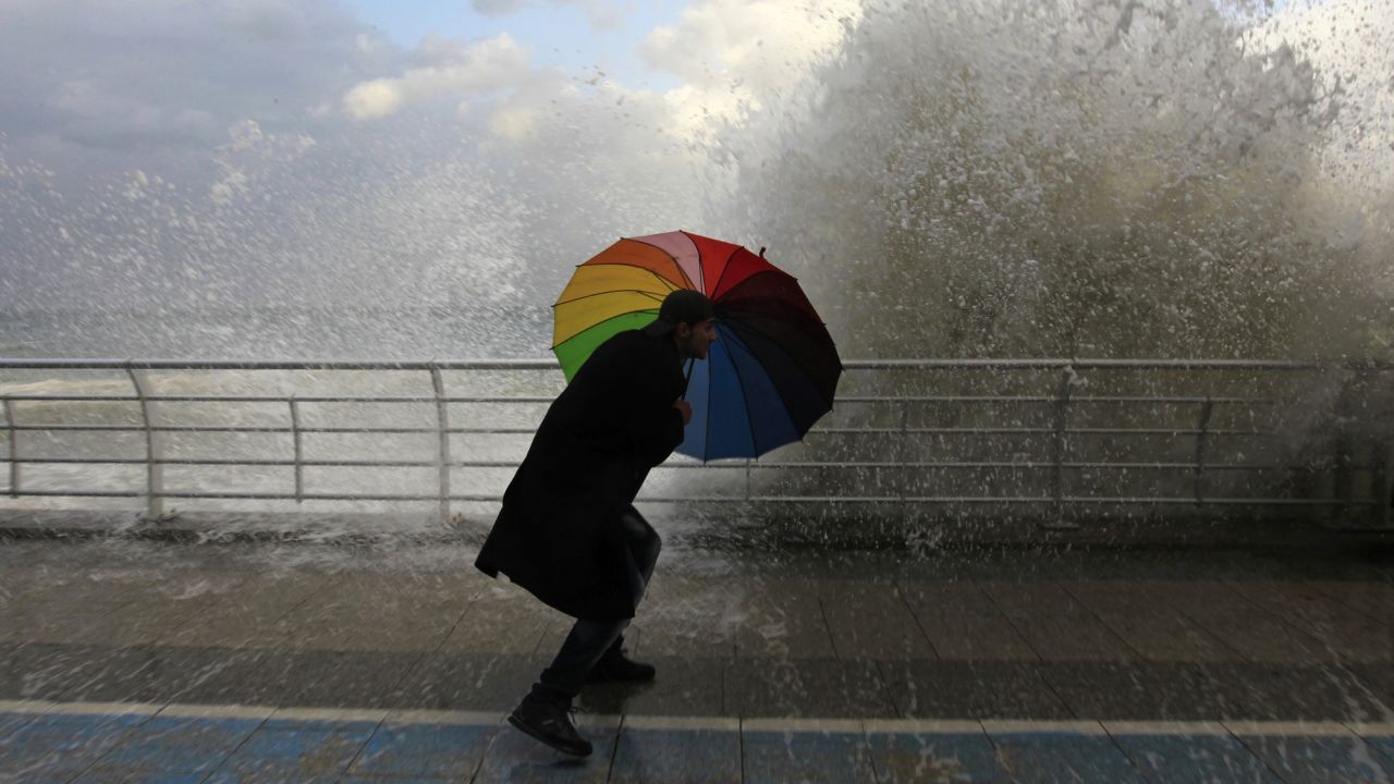 A man in Beirut, Lebanon, plays in front of a wave crashing into the Corniche, a seaside promenade, on Tuesday, January 6. <a href="http://www.cnn.com/2015/01/02/world/gallery/week-in-photos-0101/index.html" target="_blank">See last week in 30 photos</a>