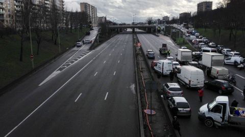 Vehicles are blocked on a road in Paris.