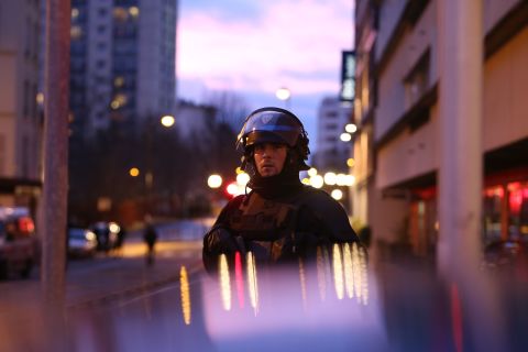 A police officer is seen at the scene of the standoff. Police union spokesman Pascal Disand said the hostage-taker, Amedy Coulibaly, demanded freedom for Cherif and Said Kouachi, the suspects in Wednesday's massacre at the Charlie Hebdo magazine office in Paris, who were simultaneously involved in a standoff wiith police northeast of Paris. Disand said the brothers and Coulibaly were part of the same jihadist groups.