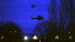 Helicopters fly over buildings in Dammartin-en-Goele, France, where there was a standoff Friday, January 9, between police and two men suspected in the Charlie Hebdo shootings earlier this week. Cherif and Said Kouachi, the two brothers wanted in the case, were killed by security forces, a local mayor said.