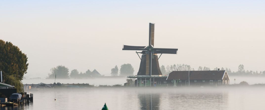 Dawn breaks over Zaanse Schans, the Netherlands, one of the few places in the world where you can still find traditional working windmills 