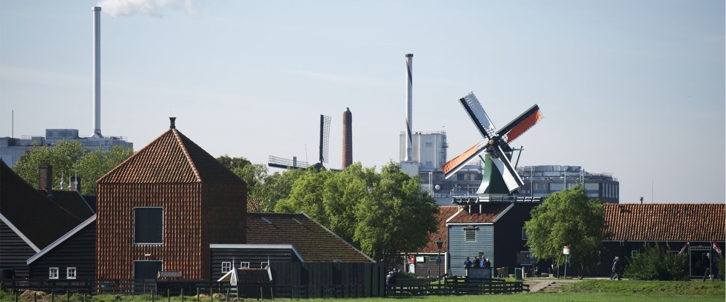 The Zaanse Schans windmills have resisted modernity, however close it may loom