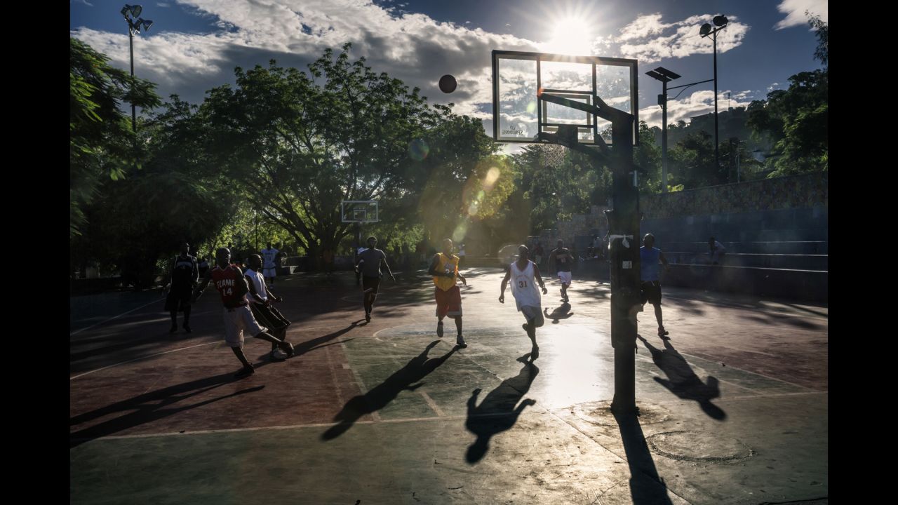 Men play basketball in the main square of the Petion-Ville district of Port-au-Prince.