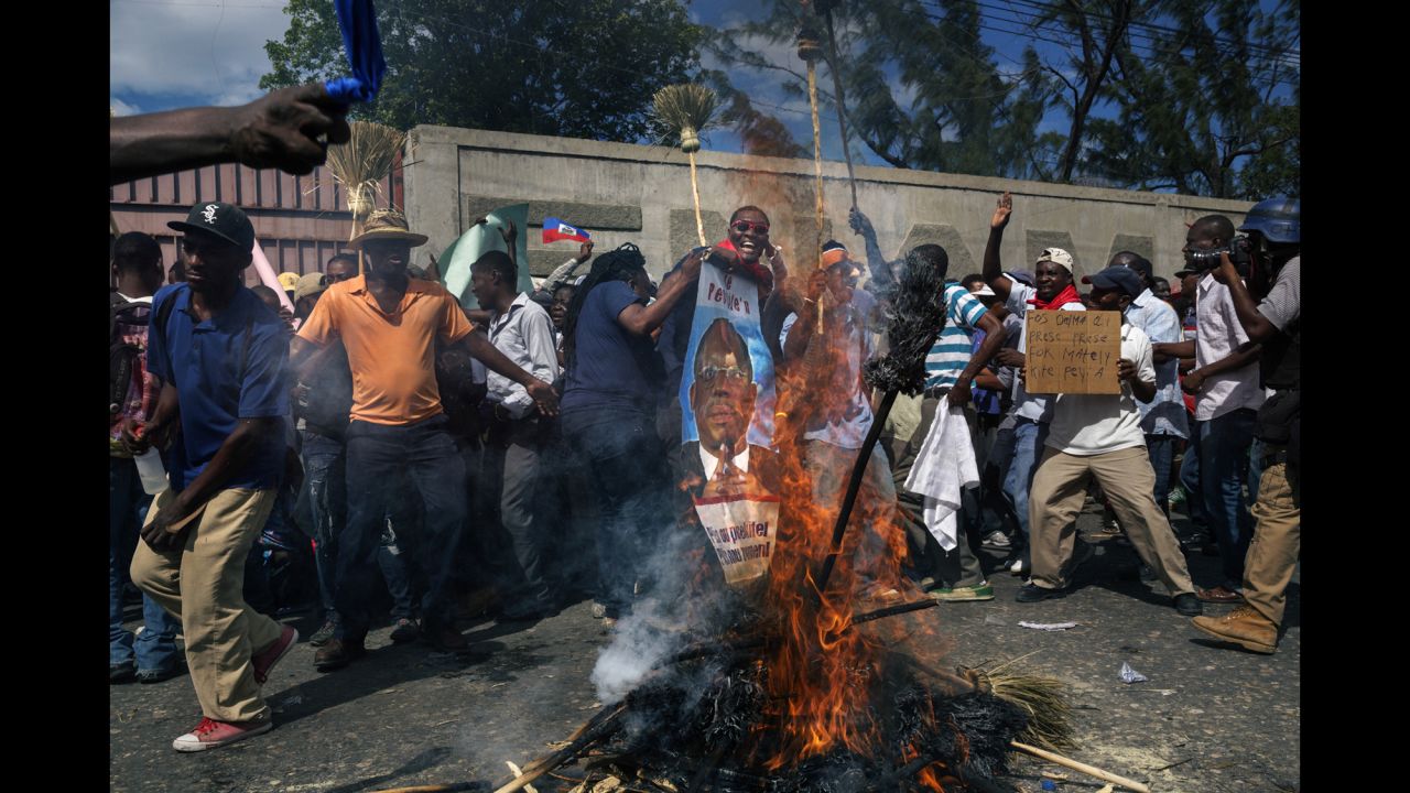 People protest against the government in the streets of Port-au-Prince.