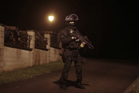 A police officer stands guard in Fleury, France, on Thursday, January 8.