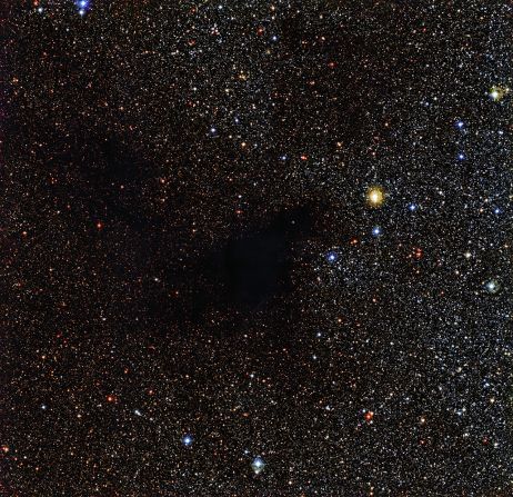 A patch of stars appears to be missing in this image from the La Silla Observatory in Chile. But the stars are actually still there behind a cloud of gas and dust called Lynds Dark Nebula 483. The cloud is about 700 light years from Earth in the constellation Serpens (The Serpent).