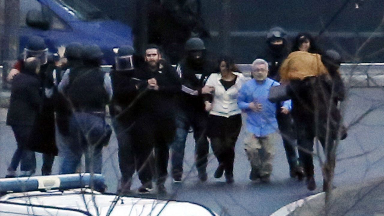French police special forces evacuate hostages after launching the assault at a kosher grocery store in Porte de Vincennes in eastern Paris.