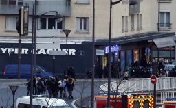 French police special forces evacuate the hostages after launching the assault at a kosher grocery store. THOMAS SAMSON/AFP/Getty Images)