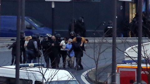 French police special forces evacuate the hostages after launching the assault at a kosher grocery store. THOMAS SAMSON/AFP/Getty Images)