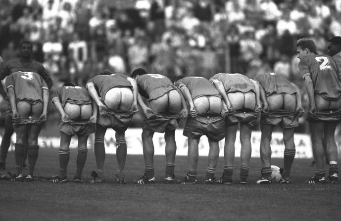 Four days after winning the FA Cup final, Wimbledon's players lined up to "moon" their home fans during a testimonial match at their Plough Lane stadium for veteran striker Alan Cork. 