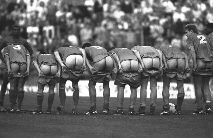 Four days after winning the FA Cup final, Wimbledon's players lined up to "moon" their home fans during a testimonial match at their Plough Lane stadium for veteran striker Alan Cork.