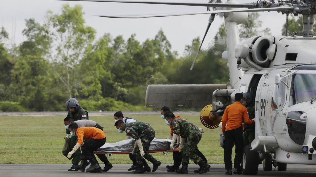 Search personnel unload the body of a victim upon arriving at the airport in Pangkalan Bun on January 9.