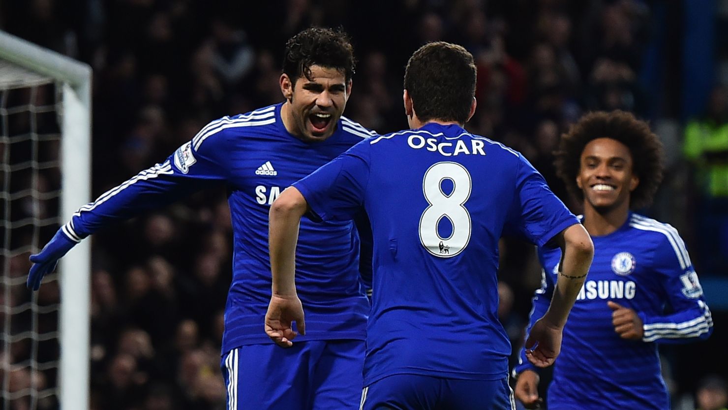 Diego Costa and Oscar celebrate as Chelsea defeat Newcastle United at Stamford Bridge.