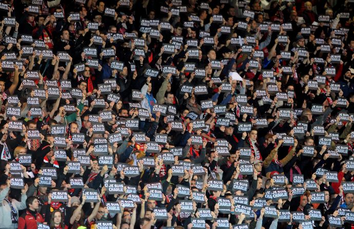 The sporting world showed solidarity with the victims of the Paris terror attacks this weekend through a range of colorful and moving tributes.<br /><br />Here, football supporter hold signs reading "Je suis Charlie" (I am Charlie) during the French Ligue 1 match between Guingamp and Lens at the Roudourou stadium Saturday.