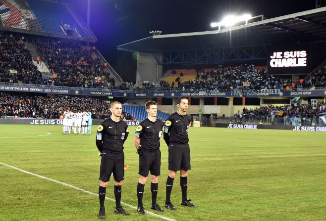 A giant screen reads "Je suis Charlie" and players stand in a huddle before the Ligue 1 match between Montpellier and Marseille, Friday.<br />