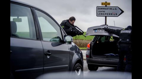A police officer checks a car in Dammartin-en-Goele.