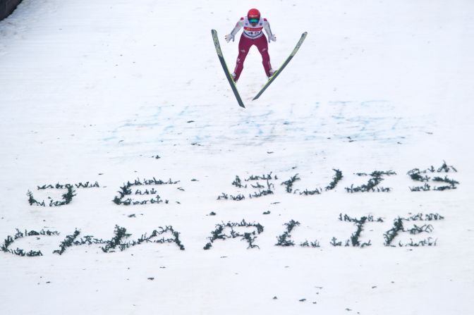 Norway's Jan Schmid soars through the air over a 'Je suis Charlie' message created in the snow at a World Cup Nordic Combined skiing event in eastern France. 