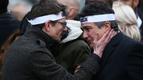 Charlie Hebdo cartoonist Renald "Luz" Luzier, left, speaks to Charlie Hebdo journalist Patrick Pelloux during the rally. Luzier is the only surviving cartoonist left at the magazine.