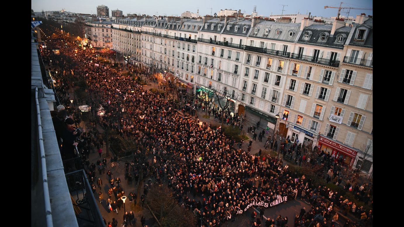 People march down Boulevard Voltaire from the Place de la Republique to the Place de la Nation in Paris on Sunday, January 11. An estimated 1.5 million people joined world leaders in the "unity rally." 