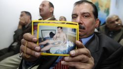 An Iraqi victim of a shooting incident holds up a picture of himself, during a meeting with US Federal Prosecutors to discuss the case against the security firm Blackwater at the central police station close to Nussur Square in central Baghdad on December 13, 2008.