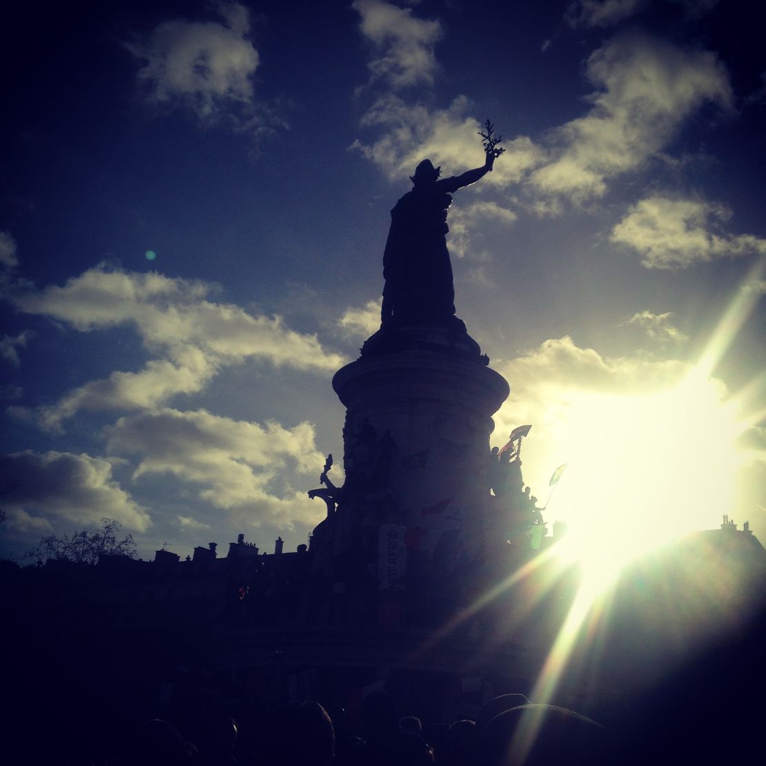 Sun breaks through the clouds over the Paris unity march.