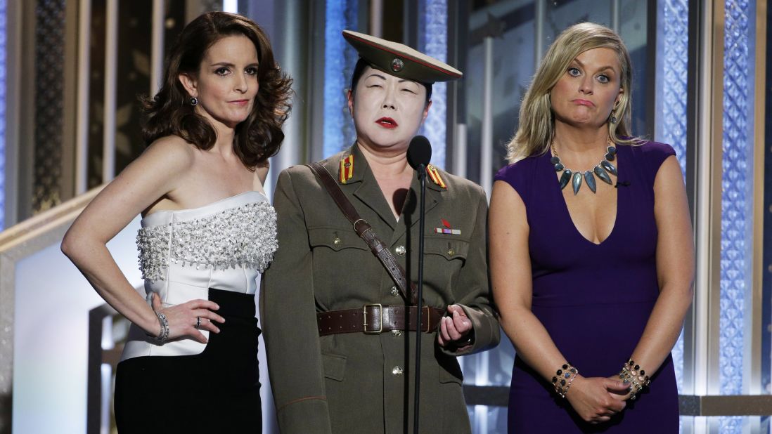 Comedian Margaret Cho, center, performs a running joke on stage with hosts Tina Fey and Amy Poehler at the Golden Globe Awards on Sunday, January 11. Cho was playing a North Korean general who was not happy with the way the awards show was progressing.