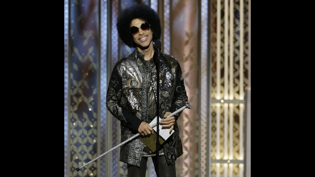Music legend Prince surprises the crowd, showing up to present the award for best original song in a motion picture.