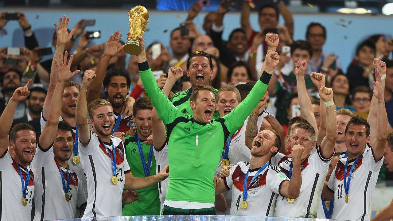 Germany keeper Neuer  lifts the World Cup trophy with his team after defeating Argentina 1-0 in the 2014 World Cup final.