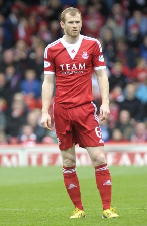 Mark Reynolds won his first domestic trophy as Aberdeen lifted the 2014 Scottish League Cup - their first silverware for 19 years.