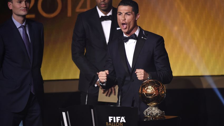 Real Madrid and Portugal forward Cristiano Ronaldo (R) reacts, next to French former star player Thierry Henry (C) and Amaury Sport Organisation (ASO) president Jean-Etienne Amaury (L), after receiving the 2014 FIFA Ballon d'Or award for player of the year during the FIFA Ballon d'Or award ceremony at the Kongresshaus in Zurich on January 12, 2015. AFP PHOTO / OLIVIER MORIN (Photo credit should read OLIVIER MORIN/AFP/Getty Images)