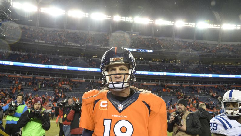 Denver Broncos quarterback Peyton Manning walks off the field after losing to his former team, the Indianapolis Colts, during a playoff game in Denver on Sunday, January 11.